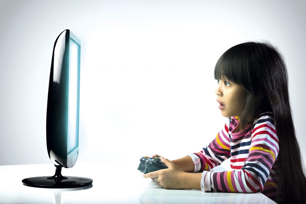 Little girl playing compter games, Kids addicted to the game concept